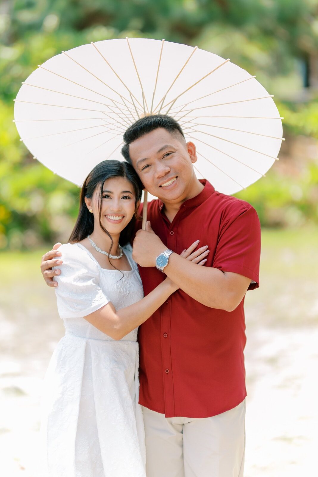 Shelo and Majorie beneath a white parasol