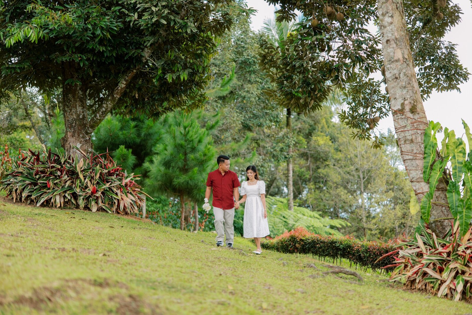 Shelo and Majorie walking hand in hand across the garden